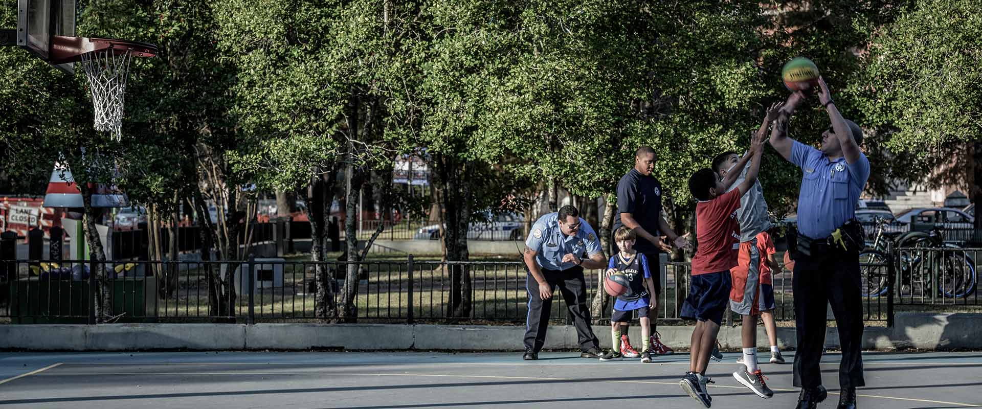 NOPD Officers playing basketball with youth