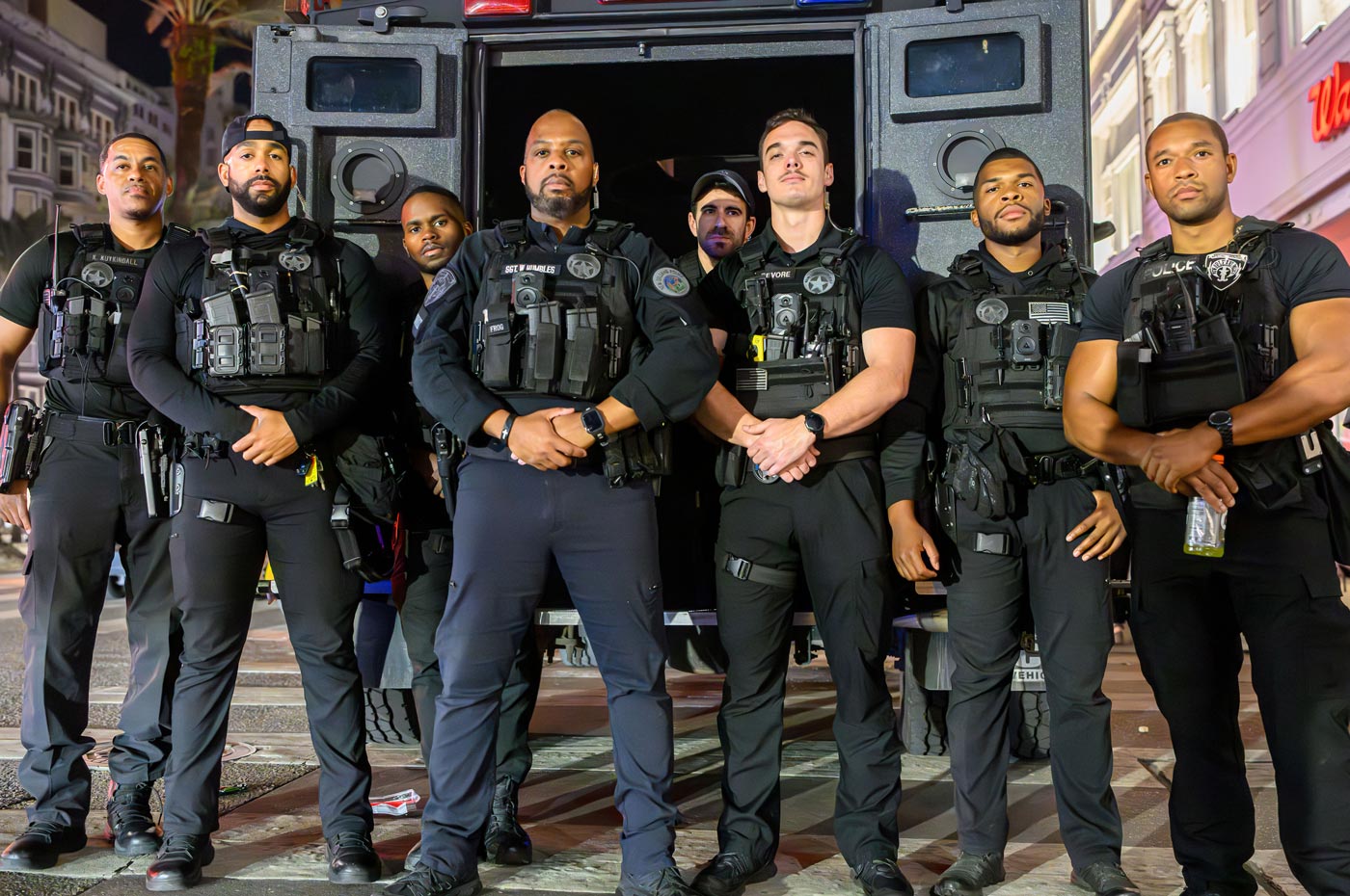 Tactical team posing in gear in front of the bearcat