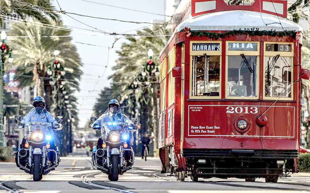 NOPD Officer on motorcycle with streetcar in background