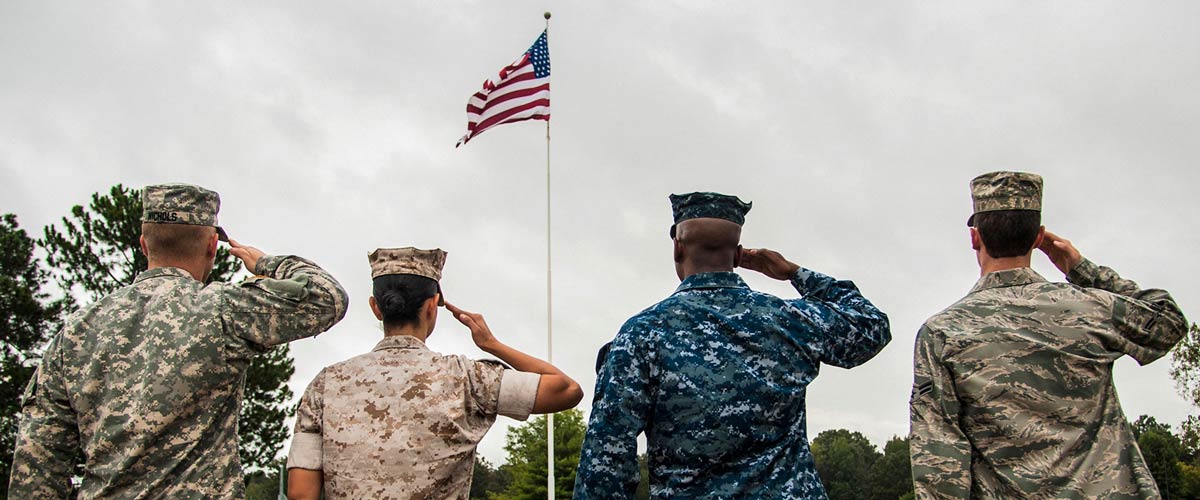 Military officers saluting the flag together