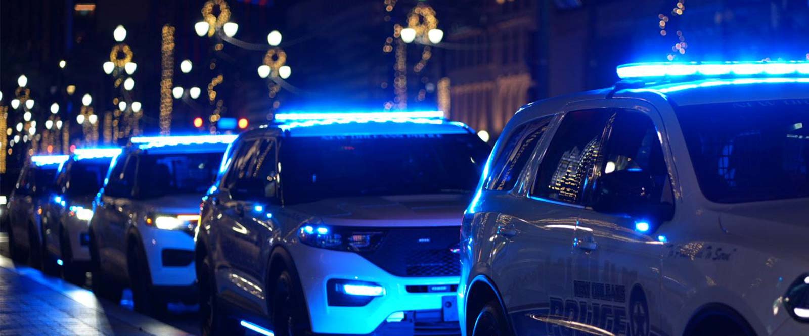 NOPD police cars at night with lights